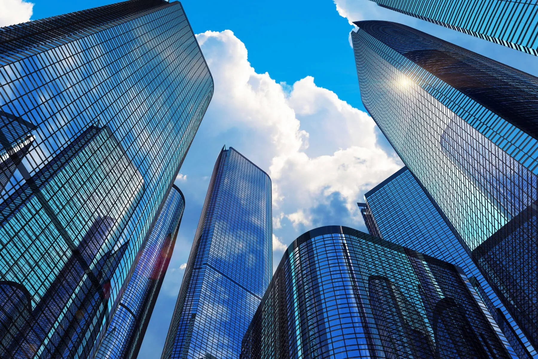 Upward view of mirrored glass office towers against blue sky and clouds — cover image for the ABS Automation website project